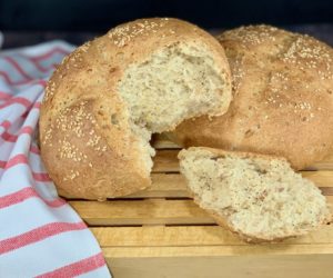 Closeup of Multigrain Sourdough Bread on cutting board with torn loaf and piece wide