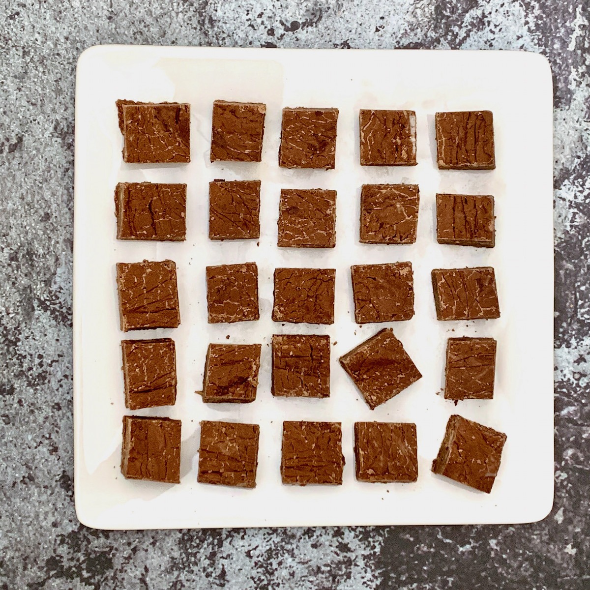 dark chocolate whisky fudge laid out on a square plate overhead