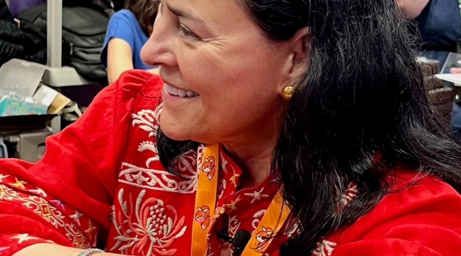 Diana Gabaldon sitting at a table for an interview.