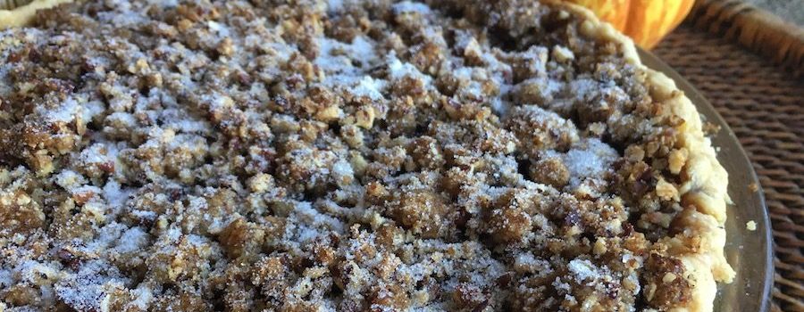 Praline Pumpkin Pie with pumpkins on tray