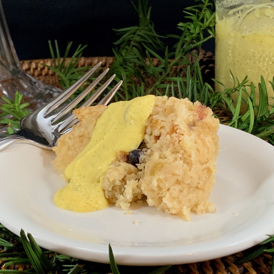 Spotted Dick steamed pudding slice plated closeup