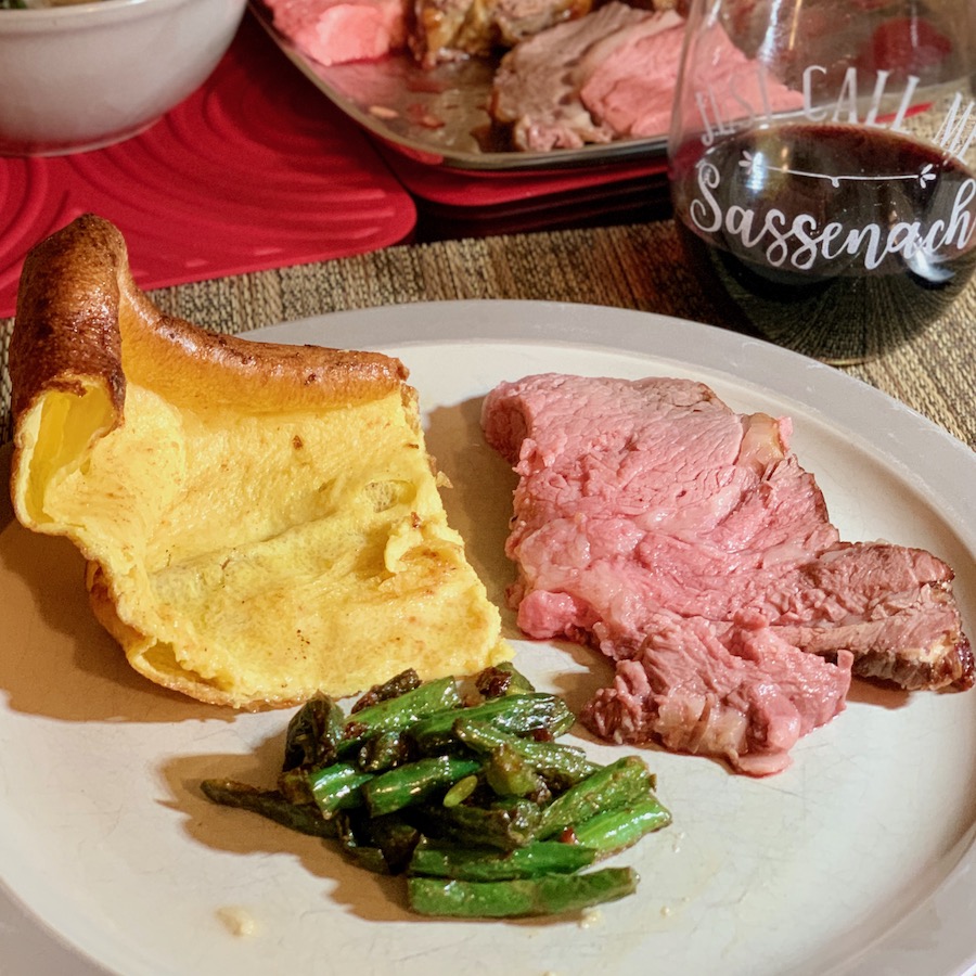 Yorkshire Pudding plated with roast beef and green beans