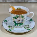 rum punch cocktail in china cup closeup wide