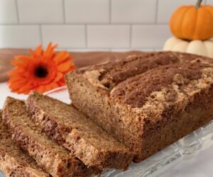 Sourdough Spice Cake sliced on plate with pumpkins closeup