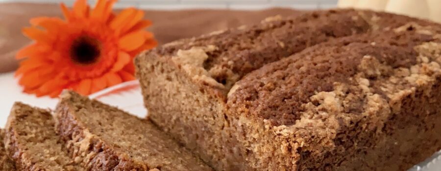 Sourdough Spice Cake sliced on plate with pumpkins closeup