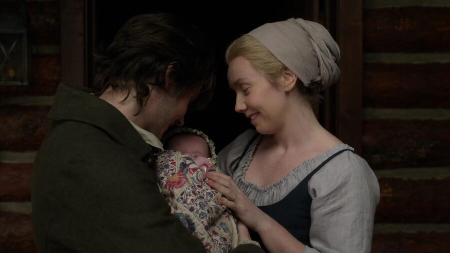 Fergus holds Henri-Christian with Marsali, both are smiling. 