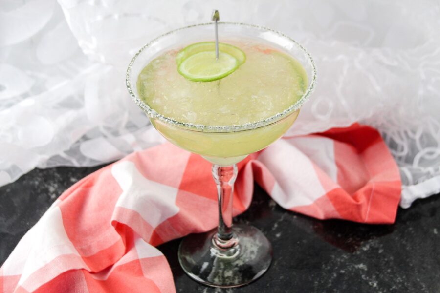 whiskey margarita in a glass with plaid napkin on a table