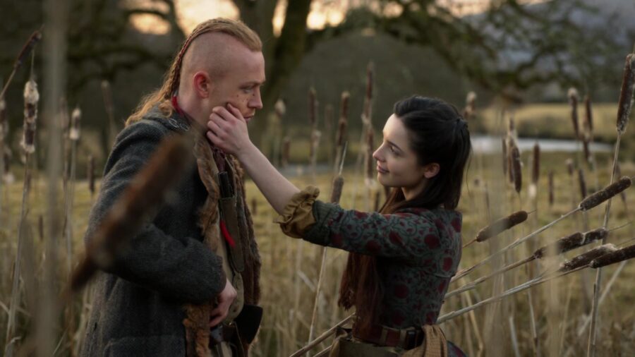 Malva touches Ian's marks on his face. 