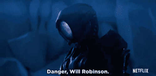 Gif reads: “Danger, Will Robinson” from the Netflix Lost in Space reboot. Robot turns to his face to the camera and then the image shifts to a 10-year-old boy, Will Robinson, looking concerned. The image is dark blue indicating a location in space.