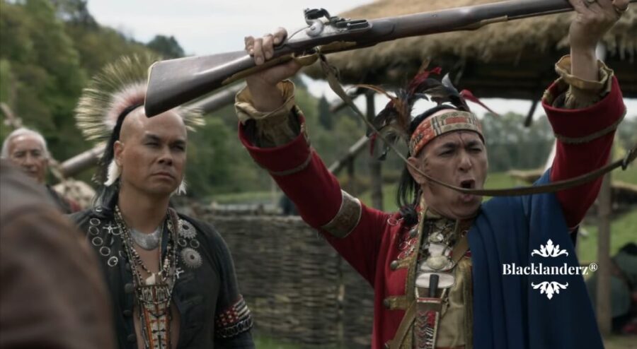 Chief Bird raising a gun from the government above his head in excitement.